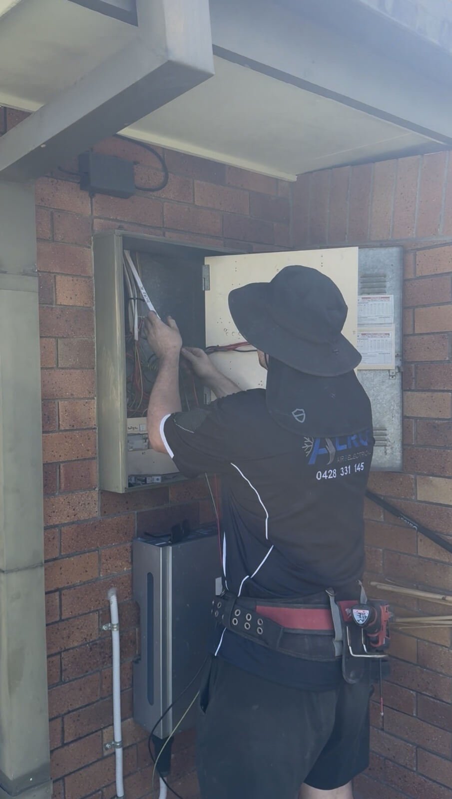 Technician carrying out electrical work for air conditioning
