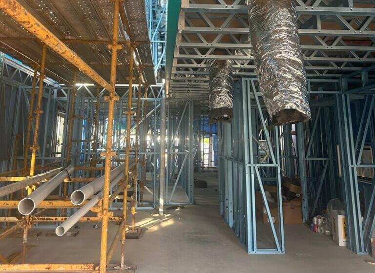 Air conditioning flexible ductwork roughed in on metal frame home.